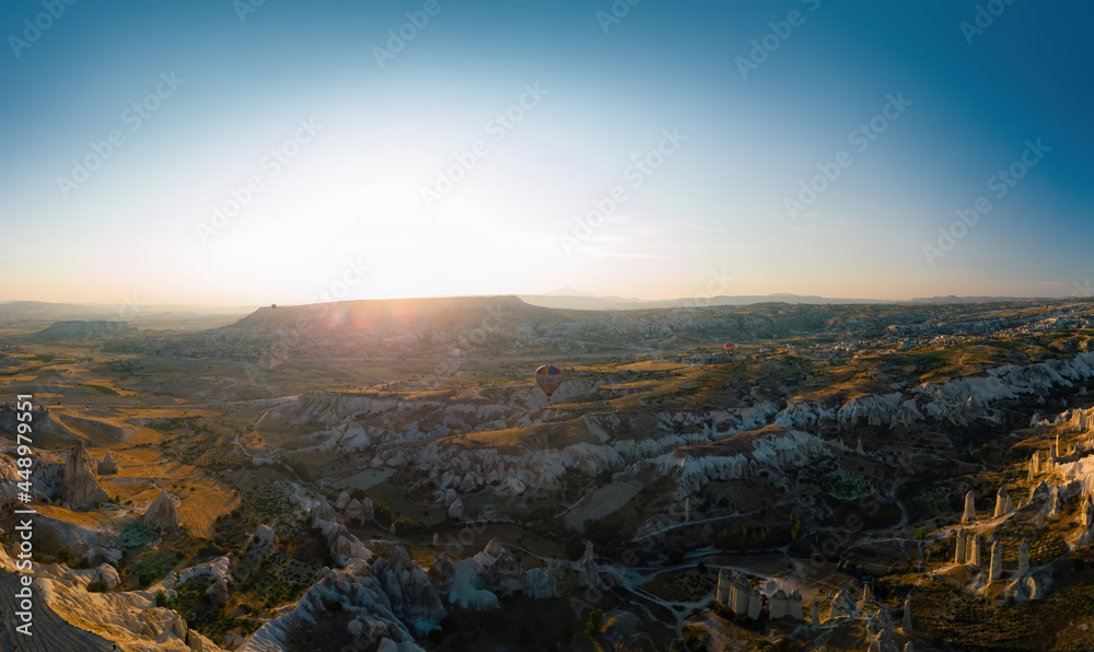Aerial wide view of Love Valley Peri Bacalari Sunset over Red valley in Cappadocia canyon, mountains and balloons.. Nevsehir Province. Turkey