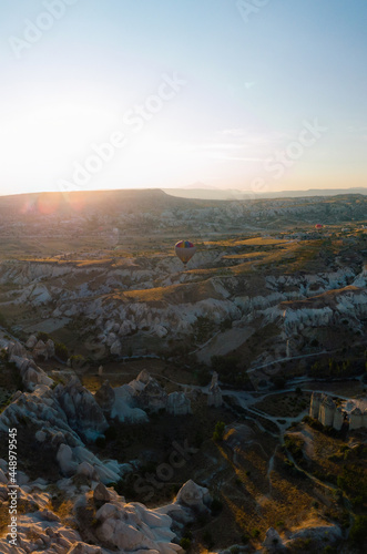 Vertical photo. Aerial view point of Love Valley Peri Bacalari Sunset over Red valley in Cappadocia canyon, mountains and balloons.. Nevsehir Province. Turkey