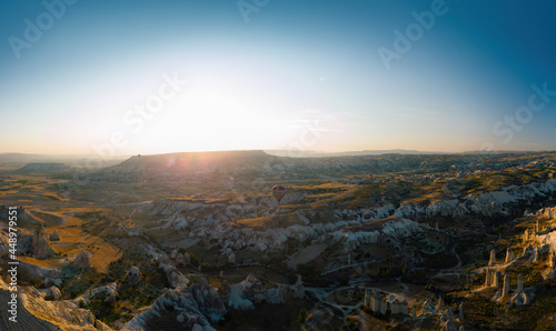 Fototapeta Naklejka Na Ścianę i Meble -  Aerial wide view of Love Valley Peri Bacalari Sunset over Red valley in Cappadocia canyon, mountains and balloons.. Nevsehir Province. Turkey