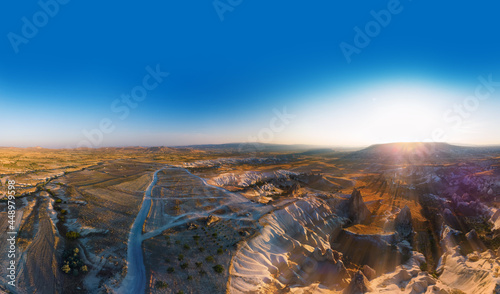 Aerial viewpoint of Love Valley Peri Bacalari Sunset over Red valley in Cappadocia canyon, mountains and balloons.. Nevsehir Province. Turkey