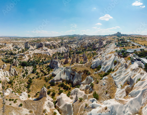 Aerial View of Goreme valley in Turkey. Panorama of Cappadocia - wide angel landscape mountain peaks of ancient cave town Uchisar.