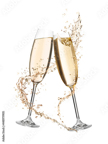 Glasses with sparkling wine and splashes on white background