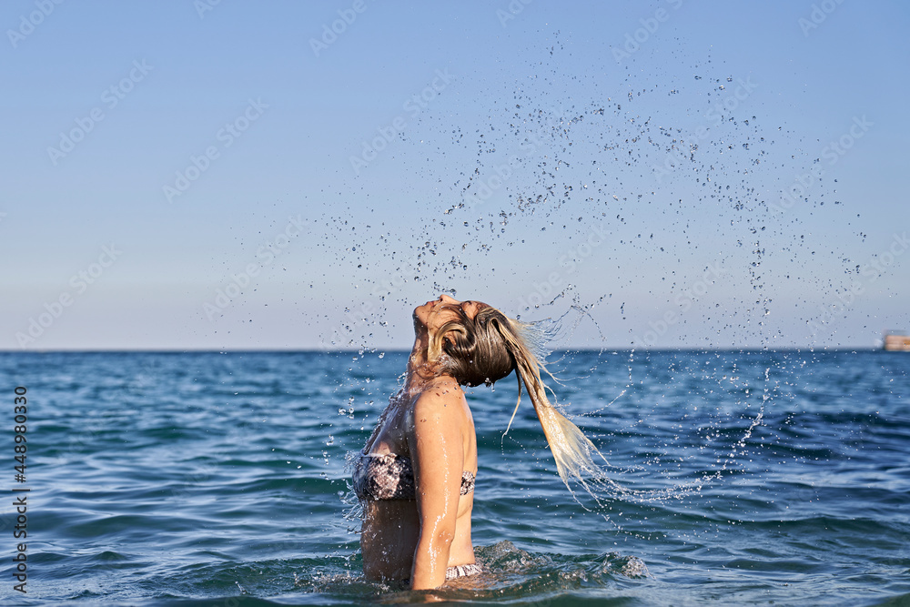 Women flipping hair in the sea