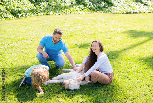 adoption and charity. family day. friendship. father mother and child on green park grass.