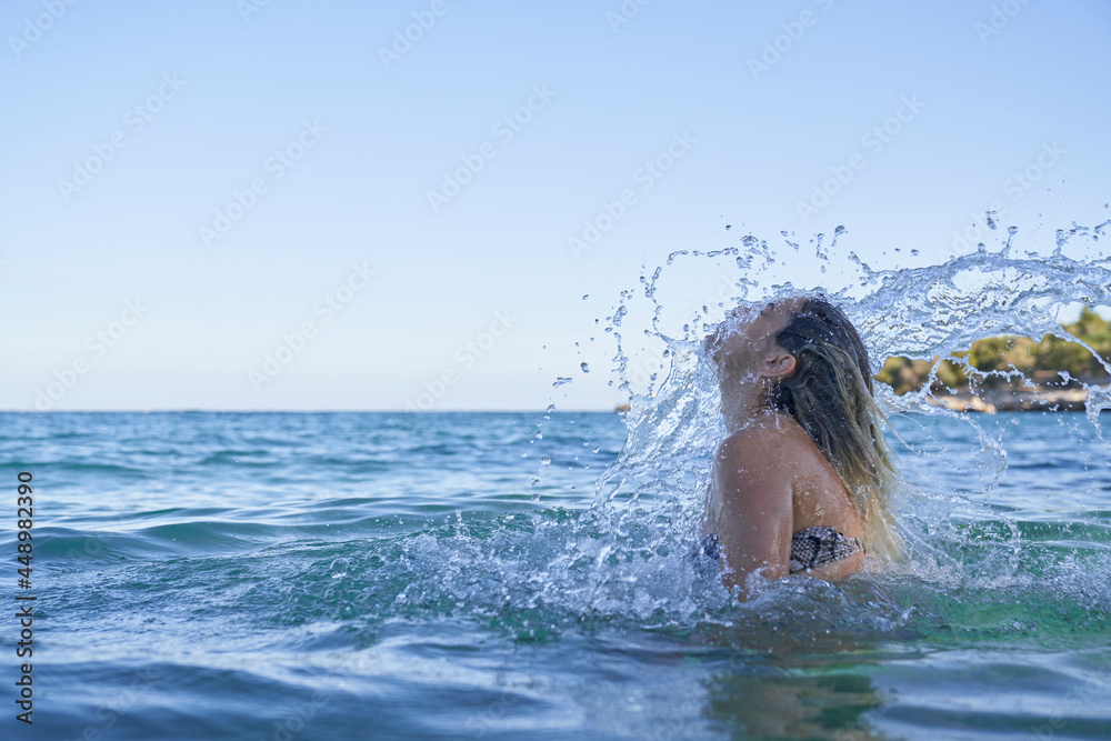 Women flipping hair in the sea