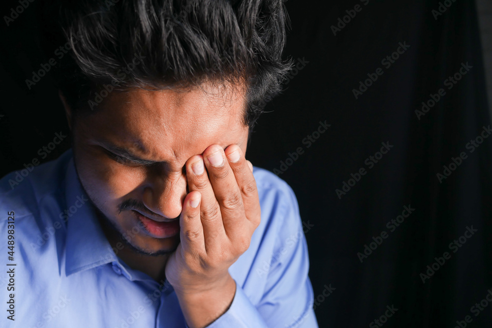 Close up of upset man suffering from strong eye pain Close up of upset man suffering from strong eye pain