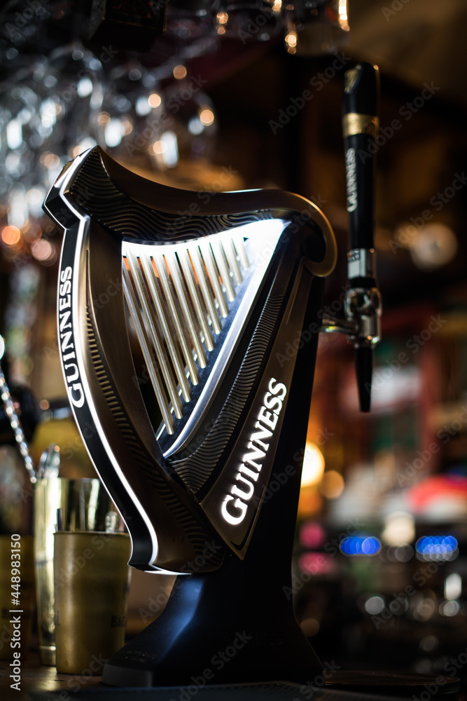 Guinness beer tap in a pub in Bucharest Photos | Adobe Stock