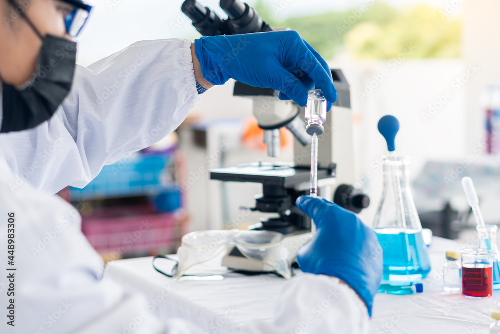 modern laboratory Scientists conduct an experiment by synthesizing a compound in a bottle in hand. Scientists are testing vaccines against COVID-19. modern laboratory Scientists conduct an experiment by synthesizing a compound in a bottle in hand. Scientists are testing vaccines against COVID-19.