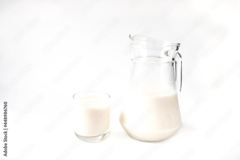 Pitcher and glass of milk isolated with white background. Pitcher and glass of milk isolated with white background.