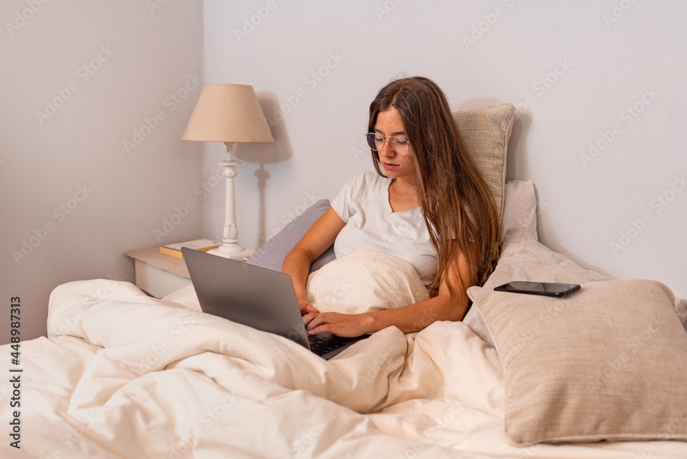 Young latin woman with computer in the bed Young latin woman with computer in the bed