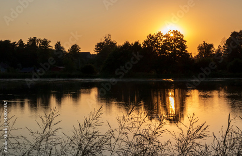 The setting sun over the pond in Ilownica
