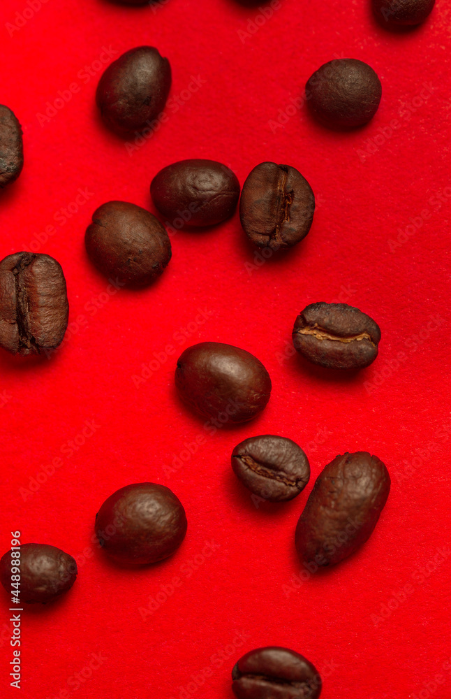 coffee beans close-up on a red background.
