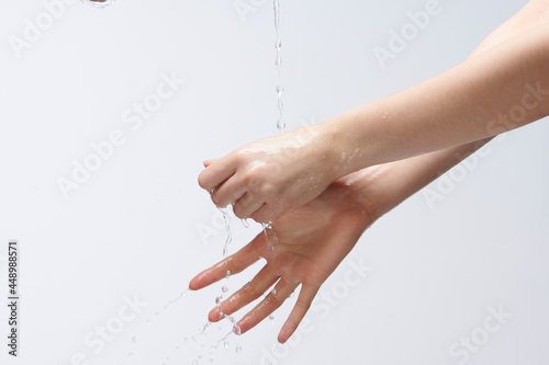 women washing hands on white background.