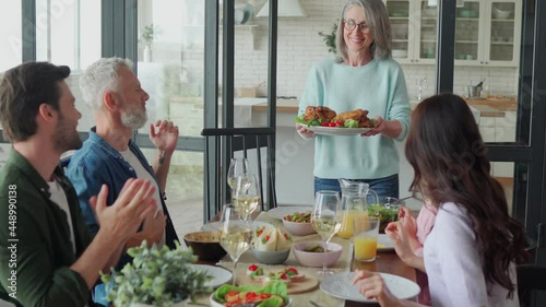 Happy multi-generation family enjoying dinner at home together