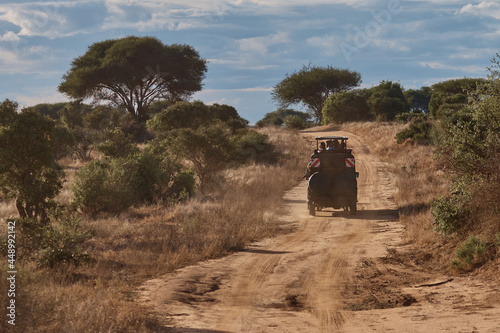 bus with tourists traveling on the road in Kenya