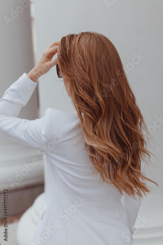 Beauty girl with brown curly hair. Healthy and long brown wavy hair. Beautiful young woman. Rear view