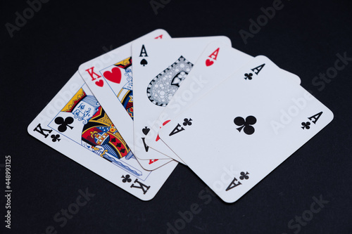 Poker Cards with full house game on black background.