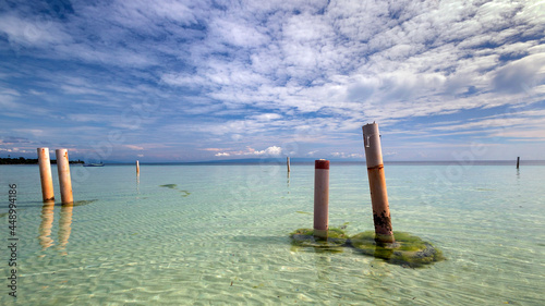 a wooden pole in a body of water