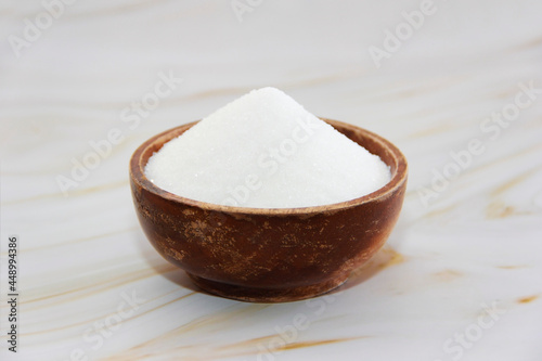 white crumbly granulated sugar in a decorative plate