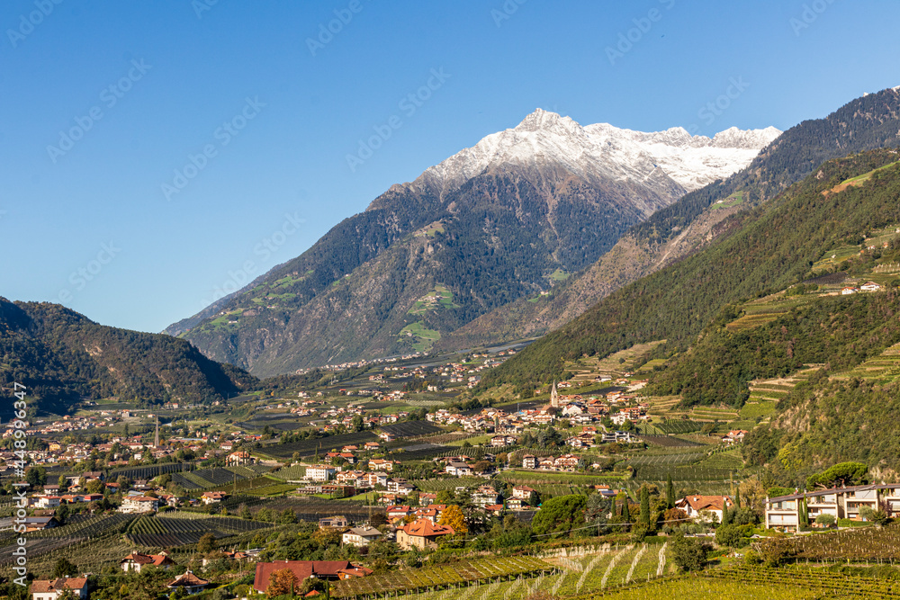 Panoramic view of Merano in Italy with mountains in background.