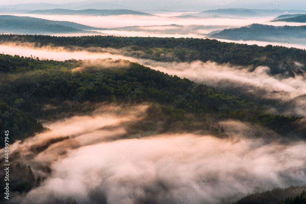 Fog in the mountains at sunrise. Morning fog in the mountains at dawn. Clouds in the mountains. Morning fog after rain. Mountains at dawn. Milk rivers. Copy space