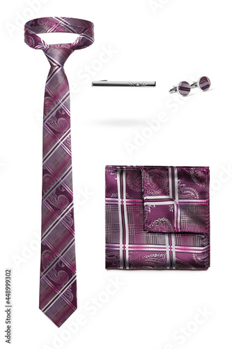 Subject shot of stylish set for office wear composed of tie with paisley and tartan pattern, silk handkerchief to match, steel tieclip and cufflinks. Accessories are isolated on the white background. photo