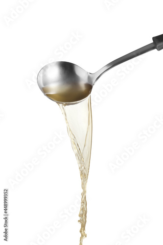Dipper pouring noodle soup on white background, Soup for sukiyaki from chicken and fish