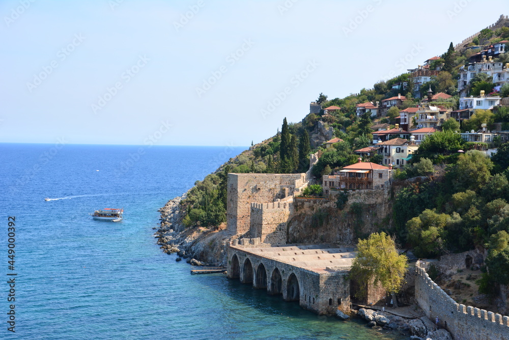 coastline with ancient fortress and small houses on top of mountain near blue sea Alanya Turkey