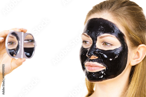 Woman with black peel off mask on face