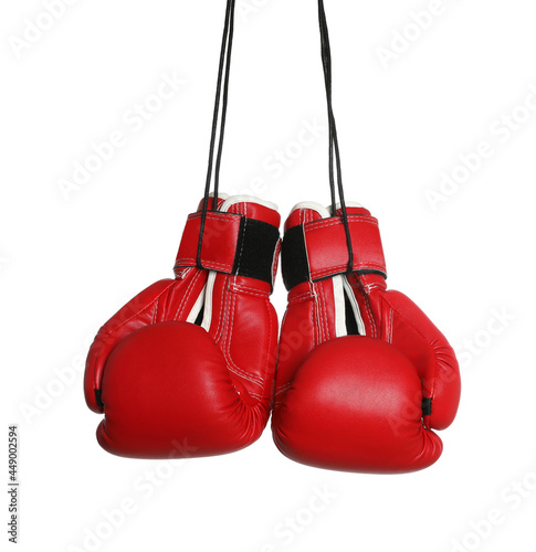 Pair of boxing gloves hanging on white background © New Africa