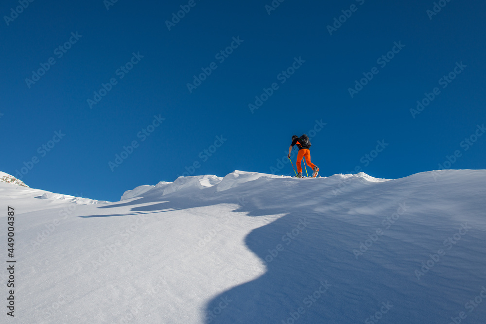 Ski touring uphill on the italian alps