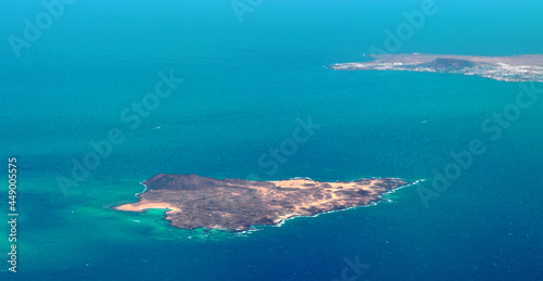 Photo taken by a plane of the Lobos Island, part of the island of Lanzarote and the Atlantic Ocean. Canary islands, Spain.