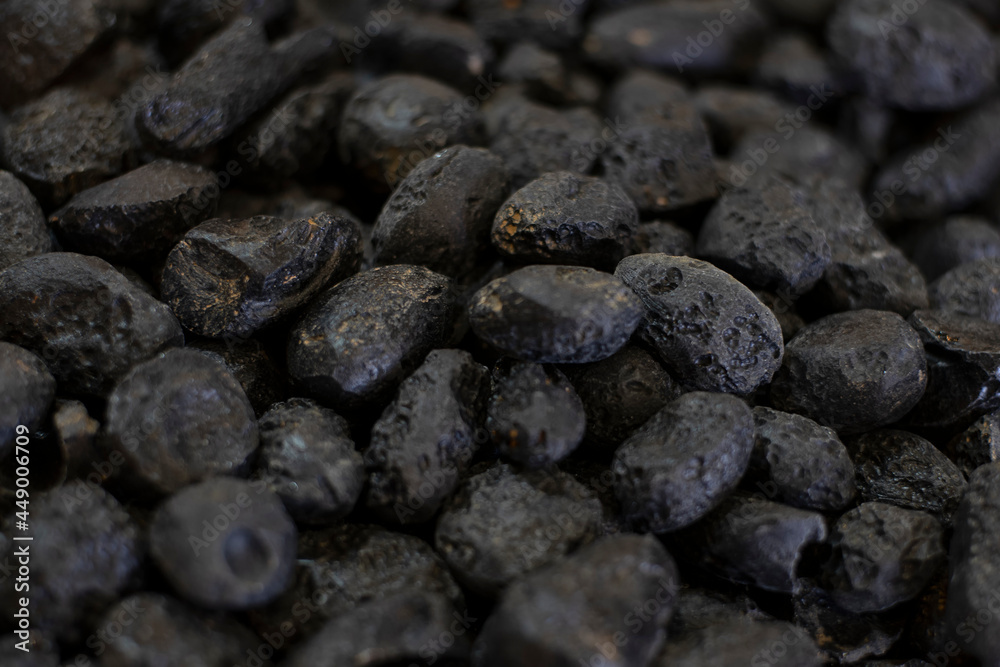 Black tektite stone or meteorite as background Black tektite stone or meteorite as background