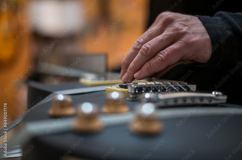 Black electrical guitar in a service repair workshop Black electrical guitar in a service repair workshop