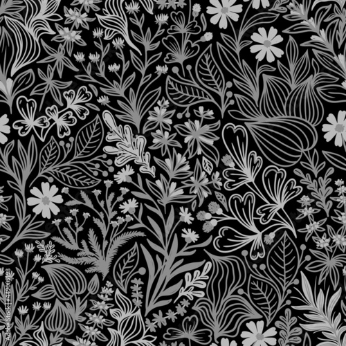 Seamless pattern with beautiful wildflowers and plants on a black background in vector © elena
