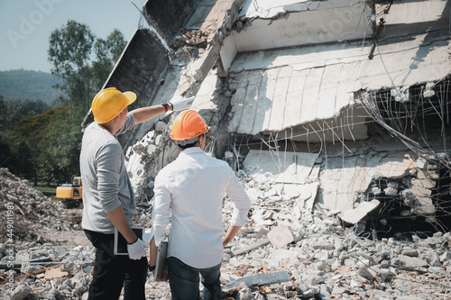 Demolition control supervisor and contractor discussing on demolish building. © skarie
