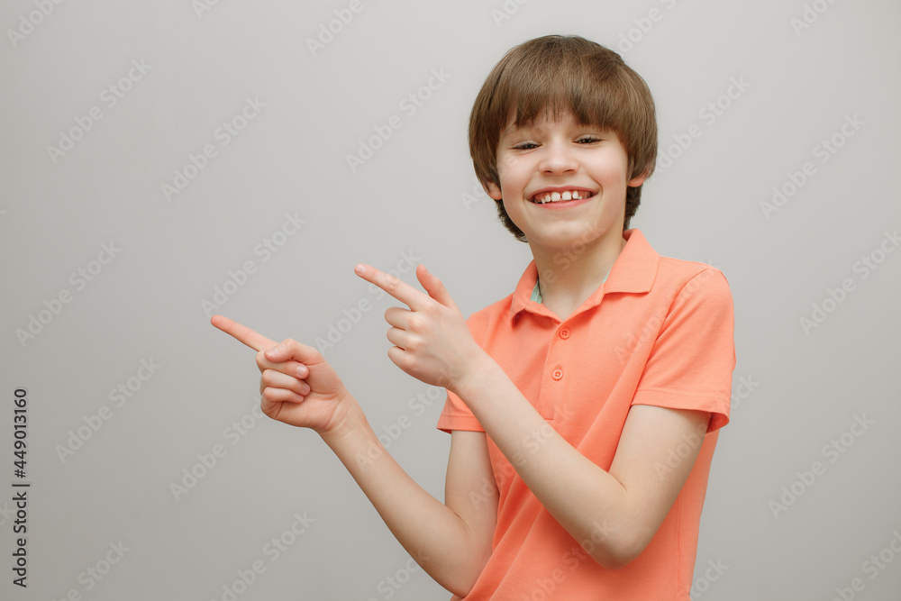 Smiling boy showing where to look. Advertising concept. Smiling boy showing where to look. Advertising concept.