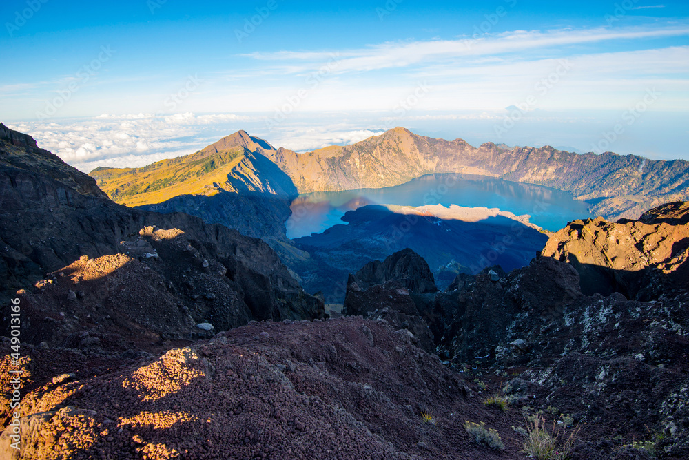 Mount Rinjani crater and a shadow cast from the peak at sunrise