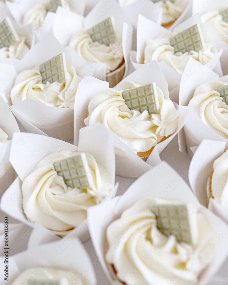 Cupcakes with white cream decorated with chocolate Cupcakes with white cream decorated with chocolate