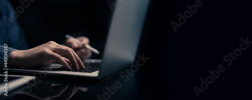 Businessman is working on Laptop. stock business or work from home concept. dark tone