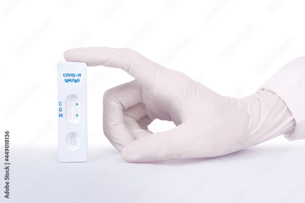Doctor or scientist hand with white glove holding a test kit for viral disease COVID-19 2019-nCoV or Lab card kit test for coronavirus SARS-CoV-2 virus Doctor or scientist hand with white glove holding a test kit for viral disease COVID-19 2019-nCoV or Lab card kit test for coronavirus SARS-CoV-2 virus