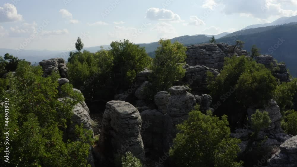 Top view of beautiful grey rock formations among green trees. Top view of beautiful grey rock formations among green trees.