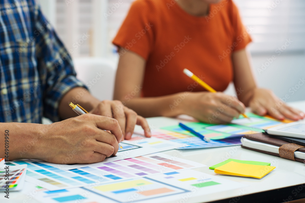 Two mobile application designers working at office desk. Two mobile application designers working at office desk.