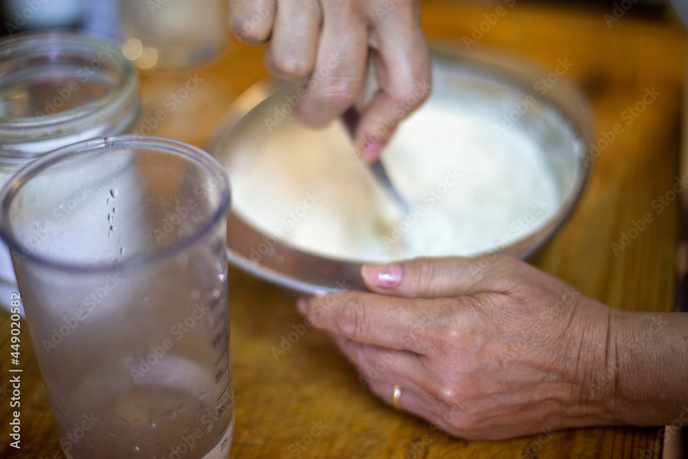 Fototapeta premium person mixing dough