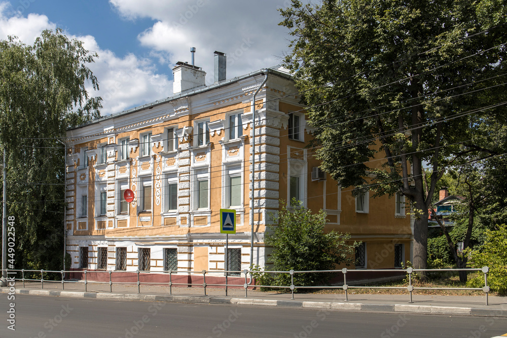 A two-story merchant mansion painted yellow on Voroshilov Street