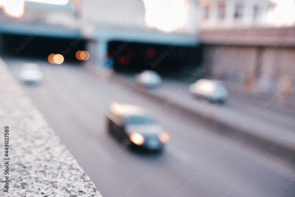 Fototapeta premium Blurred cityscape. View of the highway entering the tunnel. Abstract traffic background.