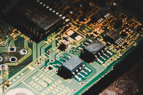 MOSFET and diode on a green circuit board with printed lettering to label the components photo