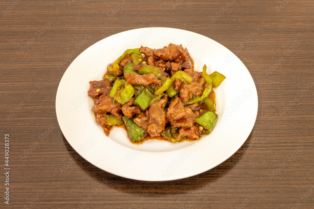 Beef stew with green peppers cooked by a Chinese chef in a Chinese food restaurant for home delivery Beef stew with green peppers cooked by a Chinese chef in a Chinese food restaurant for home delivery