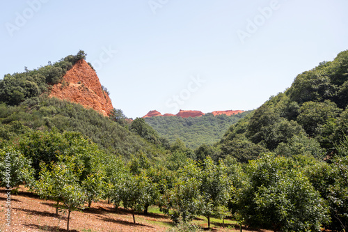 Panoramic image of the Leonese mountains of Las Medulas rich in clay and red limestone soil well covered with lush vegetation photo