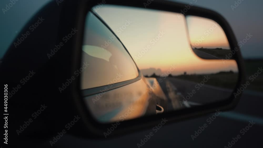 Reflection of the sunset in the car mirror Reflection of the sunset in the car mirror